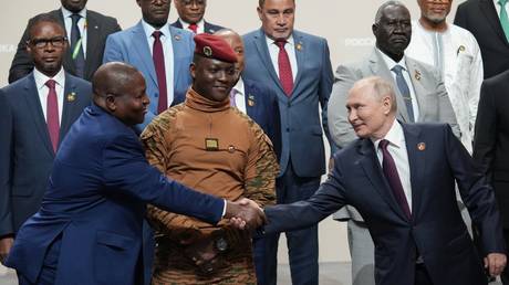 Russian President Vladimir Putin shakes hands with Mozambique President Filipe Nyusi during a family photo opportunity for heads of delegations of countries taking part in the 2nd Russia-Africa Summit and Economic and Humanitarian Forum in St. Petersburg, Russia.