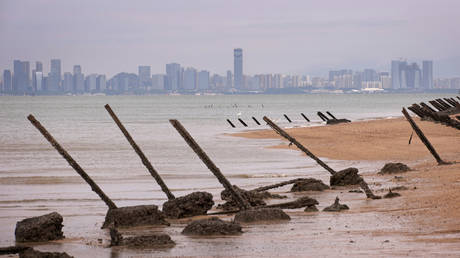 Wartime anti-tank obstacles on a beach in Kinmen, Taiwan, with Xiamen, China seen in the background a few miles away.