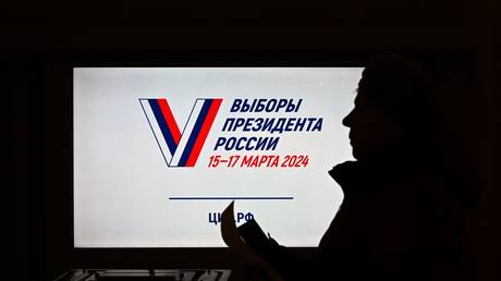 A woman votes at a polling station during the presidential election in Luhansk, Luhansk People's Republic, Russia.