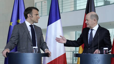 German Chancellor Olaf Scholz talks to French President Emmanuel Macron at a press conference in Berlin, March 15, 2024