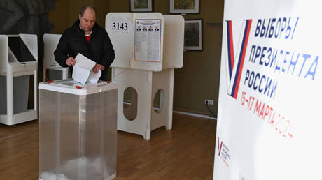 FILE PHOTO: A man casts his ballot at a polling station during the presidential election in Moscow, Russia.