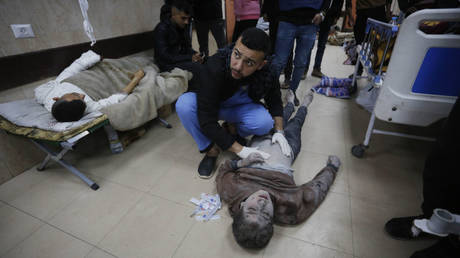 A doctor examines a patient on the floor earlier this week at Gaza's Al-Aqsa Martyrs Hospital.