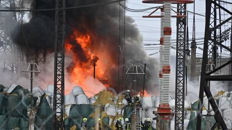 Firefighters extinguish a fire at an electrical substation after a missile attack in Kharkov, Ukraine