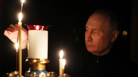 Russian President Vladimir Putin lights a candle to commemorate victims of a terrorist attack on the Crocus City Hall concert venue on the day of national mourning, in Russia.