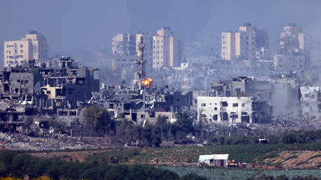 FILE PHOTO: A missile strikes behind a minaret in Gaza.