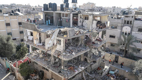 Palestinians gather to inspect damage of the destroyed building in Rafah, Gaza on March 25, 2024