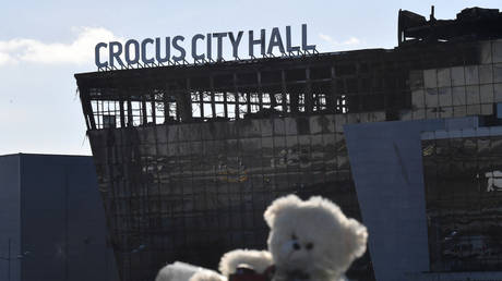 Flowers and toys are seen left by the burnt-out Crocus City Hall concert venue in Krasnogorsk, outside Moscow, on March 25, 2024.
