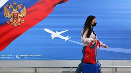  A young woman walks at Sheremetyevo Airport, outside Moscow, Russia.