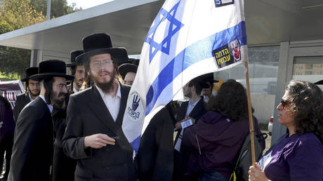 FILE PHOTO: Israeli protesters confront Ultra-Orthodox Jews outside an army recruiting office in Kiryat Ono near Tel Aviv, March 5, 2024.