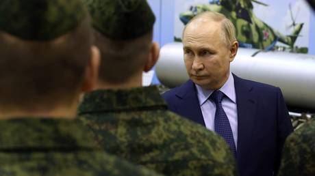 Russian President Vladimir Putin talks to military pilots as he visits the State Centre for Deployment and Retraining of Flight Personnel of the Russian Defence Ministry in Torzhok, Tver region, Russia.