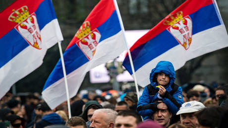FILE PHOTO: Serbian national flags fly as thousands of people from all over Serbia march in central Belgrade.