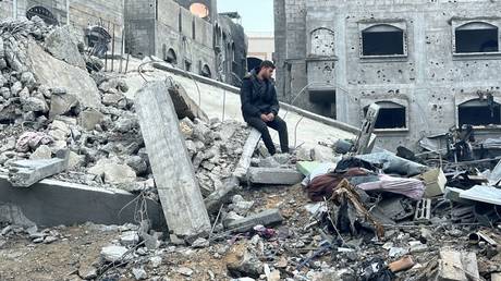 A man sits on the rubble of a building destroyed by an Israeli bombardment last month in Beit Lahia, Gaza.