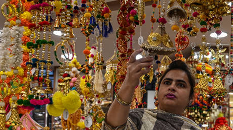 Shoppers buy decorative items ahead of the Hindu festival of 'Diwali' at a market area in Amritsar on October 21, 2022.