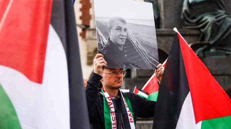 A demonstrator in Krakow, Poland, displays a photo of one of the aid workers killed in an Israeli drone attack on Monday.