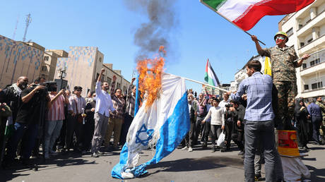 Demonstrators burn Israeli flags during the funeral of seven Revolutionary Guard Corps officers killed in a strike on Iran's consulate in Damascus. Tehran, Iran, April 5, 2024
