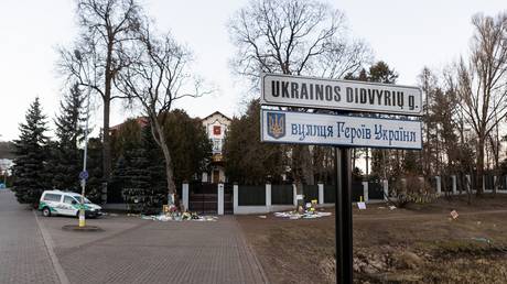 FILE PHOTO: A street sign in front of the Russian embassy in Vilnius marking the location as Ukrainian Heroes Street in Lithuanian and Ukrainian.