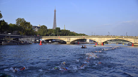 FILE PHOTO: A general view as athletes swim in the Seine river in front of the Eiffel Tower during the Women World Triathlon on August 17, 2023 in Paris, France.
