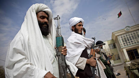 FILE PHOTO: Taliban militants stand with their weapons in Herat, Afghanistan.