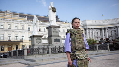 FILE PHOTO: A woman demonstrate body armor during a presentation in Kiev, September 14, 2023