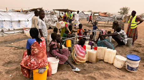 FILE PHOTO: Refugee women from Sudan at the water point in Transit Camp 1 in the southern Sudanese border town of Renk.