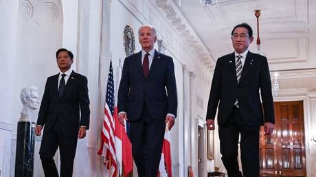 Joe Biden (C) heads to a trilateral meeting with Fumio Kishida (R) and Ferdinand Marcos Jr. (L) at the White House in Washington DC, April 11, 2024