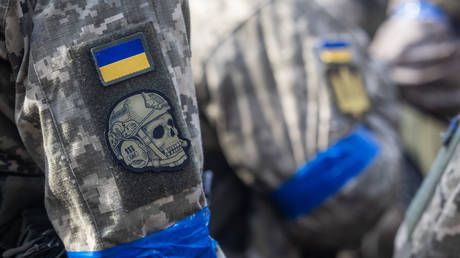 A patch with the Ukrainian flag on a trooper's arm as Ukrainian soldiers take part in a military training in Poland, on April 4, 2024