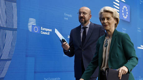 European Council President Charles Michel (L) and President of the European Commission Ursula von der Leyen leave after a press conference.