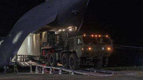 A US-made Typhoon Mid-Range Capability (MRC) missile system being unloaded from a cargo plane.