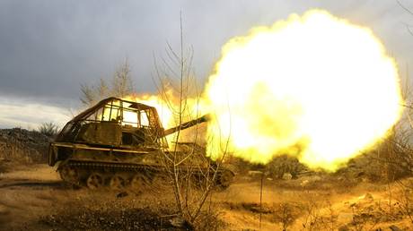 Russia servicemen fire a 2S3 Akatsiya self-propelled howitzer towards Ukrainian positions.
