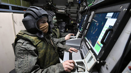 FILE PHOTO. Servicemen of the Russian Air Defense Forces are seen at their workplaces in the combat control vehicle.