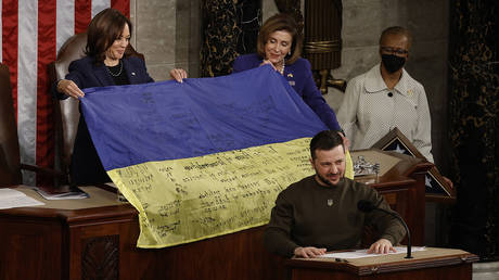 FILE PHOTO: US Speaker of the House Nancy Pelosi and Vice President Kamala Harris hold a Ukrainian flag signed by members of the that country's military given to them by President of Ukraine Volodymyr Zelensky as he addresses a joint meeting of Congress in the House Chamber of the US Capitol.