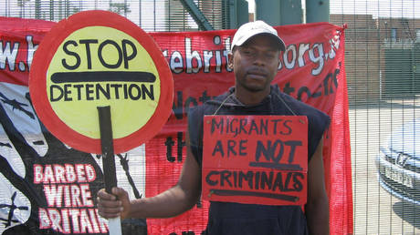 Anicet Mayela, a Congolese migrant who later pled guilty to child rape, protests outside a detention center near Oxford, England, in June 2005.