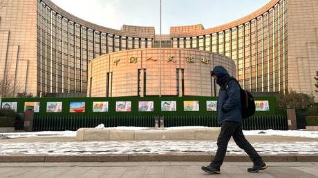 FILE PHOTO A man walks past the People's Bank of China (PBOC) building in Beijing, China, December 25, 2023.