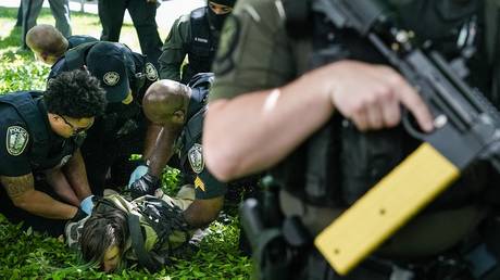 Police detain a demonstrator during a pro-Palestinian protest at Emory University on April 25, 2024.