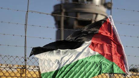 A Palestinian flag on the fence of Israel's Ofer prison near the city of Ramallah in the occupied West Bank