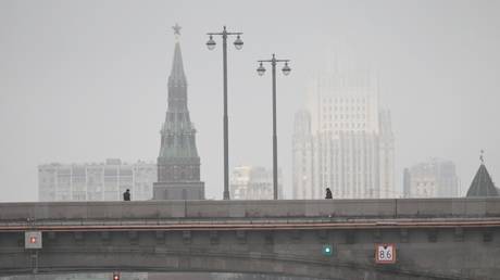 The Vodovzvodnaya Tower of the Moscow Kremlin and the building of the Russian Foreign Ministry during foggy weather in Moscow,