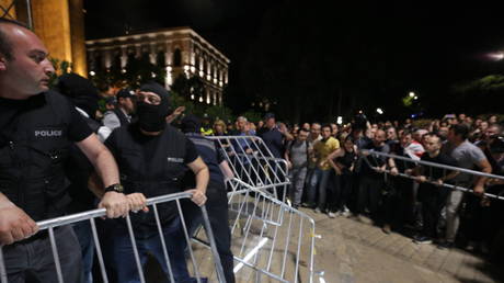 Demonstrators attempt to break through the barriers near the parliament building in Tbilisi, Georgia, April 28, 2024