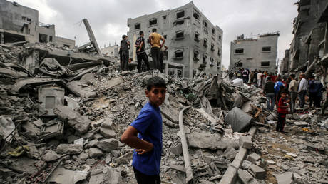 Palestinians inspect the rubble following Saturday's Israeli bombardment of the Nuseirat camp in central Gaza.