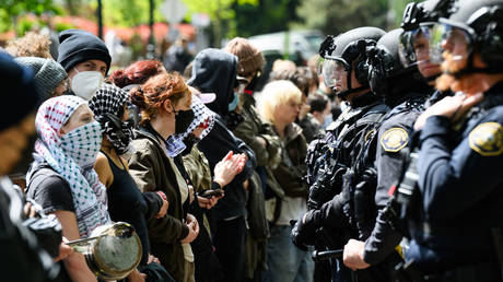 Police and pro-Palestine protesters stand-off in front of the barricaded Portland State University library on May 2, 2024 in Portland, Oregon