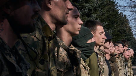  Young recruits undergo military training in the form of an obstacle course at the recruiting center in Kiev.