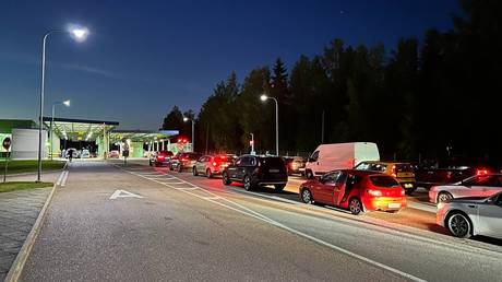 FILE PHOTO: Cars queue to enter Finland from Russia at the Brusnichnoye multilateral automobile checkpoint, Russia.