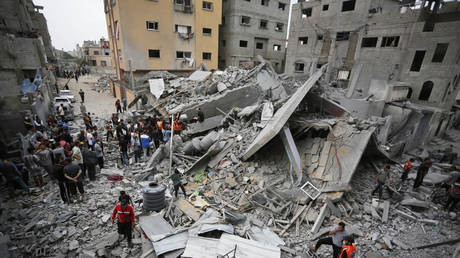 Gaza residents search for survivors in the rubble of a house destroyed in an Israeli strike on Nuseirat Refugee Camp, May 10, 2024