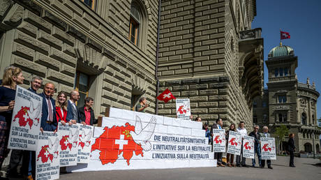 Activists pose during the handover of around 140,000 citizens’ signatures to the Swiss Chancellery as part of a popular “neutrality initiative” on April 11, 2024, Bern, Switzerland.