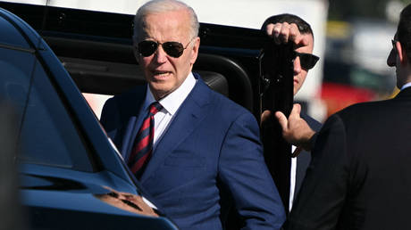 US President Joe Biden listens to a question from reporters before boarding a limousine upon arrival at Seattle-Tacoma International Airport, in SeaTac, Washington, on May 10, 2024.