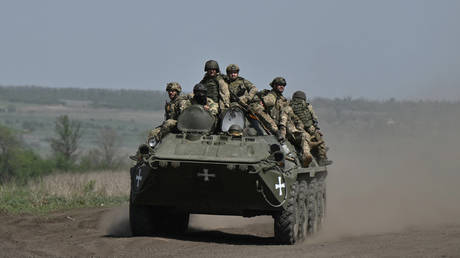 FILE PHOTO: Ukrainian servicemen ride on an armored personnel carrier.