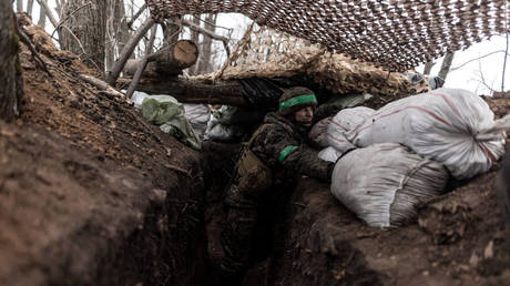 Ukrainian soldiers keep watch from a trench in Kharkov Region, Ukraine, March 10, 2024