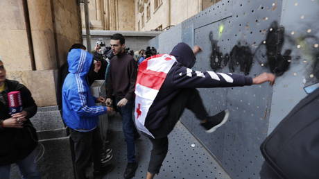 Protesters attack the barricade around the Georgian Parliament in Tbilisi, May 14, 2024.