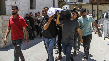 A body is brought to Al-Ahli Arab Hospital in Gaza City for burial following an Israeli attack on Tuesday.