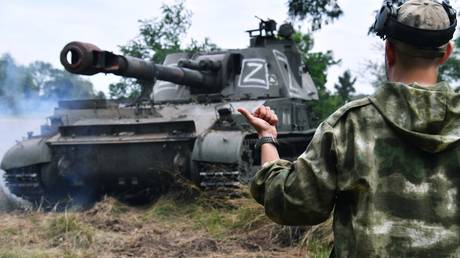 FILE PHOTO: A serviceman directs a 2S3 Akatsiya self-propelled howitzer in the course of Russia's military operation in Ukraine, in Kharkiv region.