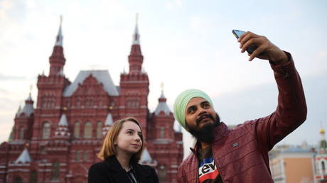 A tourist makes a selfie at the Red Square with the State Historical Museum in the background, in downtown Moscow, Russia.
